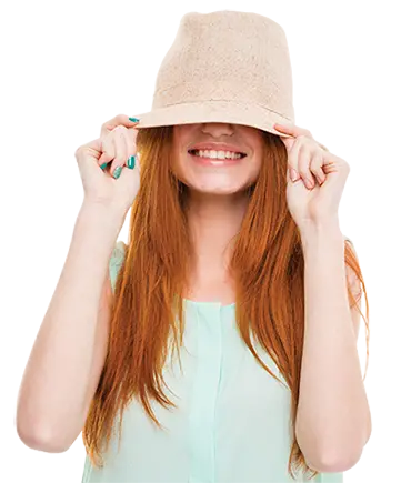 Lady holding hat over her face.